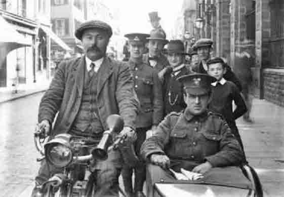 A wounded soldier is given a lift in a sidecar after returning home in 1914