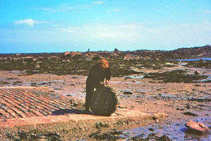A fisherman with a traditional willow prawn pot