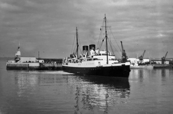 Isle of Sark' turning in St Helier Harbour in 1958 after passing through the pierheads on a high tide ...