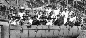 A large group with a hired charabanc for a 1920s picnic outing