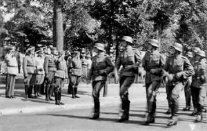 Capt Gussek takes the salute as troops march past in the Victory Parade