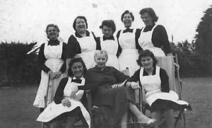 Staff photographed with a guest in the early years