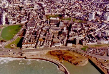St Helier stretches out behind the Esplanade with People's Park and Victoria Park on the far left