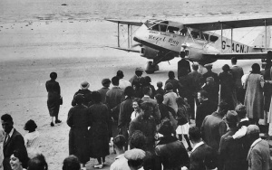 A large crowd frequently gathered around aircraft waiting on the beach with passengers ready to board and family and friends wanting to say bon voyage