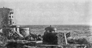 Next to the coastal tower: a German gun which was demolished after the German Occupation