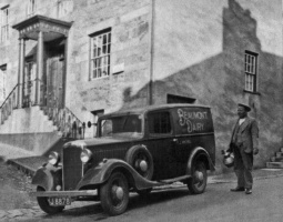 Frederick John Michel (1885-1940) (St P) with his Beaumont Dairy van in 1933 in St Aubin's High Street.