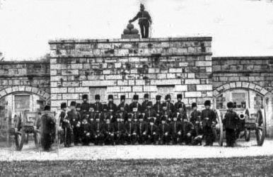 A militia group in front of an arsenal