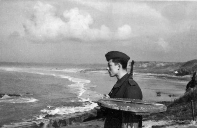 A sentry at L'Oeillere, with the sweep of the bay behind