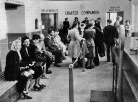 Passengers wait for their flight