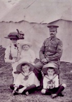 A militiman and his visiting family at a Les Quennevais camp