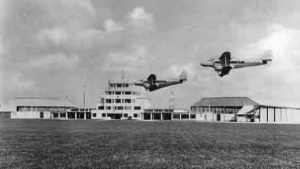 Two de Havilland aircraft land together from the south at Jersey Airport
