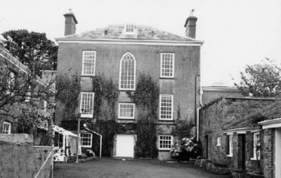 The rear of the house. The lower level is the cellar, with a large door which was reputedly used for access by a horse and small cart