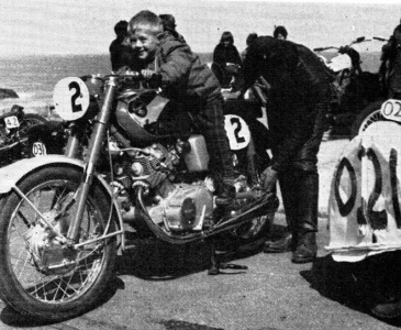 Young Marcus Bisson, who would later race up the hill himself, tries his father's bike for size