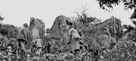 Visitors to the property clamber over the rock in the 1930s