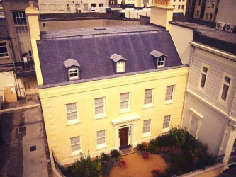 16 New Street as it is today, although not quite as yellow as the sunlit facade appears in this aerial view