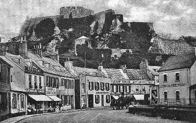 The railway has arrived and Carrel's Temperance Hotel can be clearly seen in the middle of the photograph, with a horse-drawn carriage about to pass it. Also shown in the picture are Stevens' Eastern Railway Tearooms, Marshall's Cadena Tearooms, Nelson House tearooms, and Single's Mont Orgueil tearooms.
