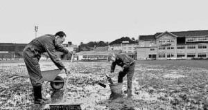 Alf Moignard and Jack Bertram working on a waterlogged pitch in 1980