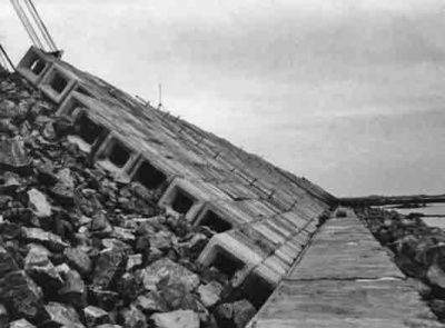 May 1975 - the cobs sit on the toe wall and are held in place by their weight. The honeycomb network dissipates the force of waves