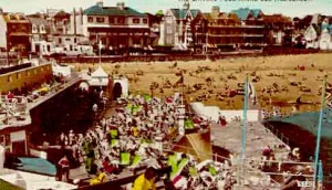 A crowded pool and beach in the 1950s