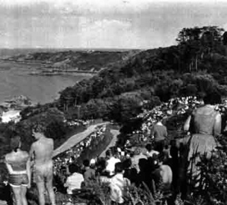 A large crowd of spectators in the 1950s
