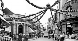 The street was decorated for Elizabeth II's Coronation. No 43 is the property on the right, with signage for the McKenzie family's tobacconist business