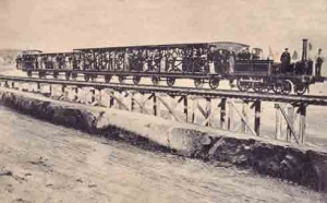 The first train on the St Aubin route crossing the La Haule sands on rails laid on trestles
