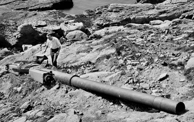 A gun dumped over a cliff