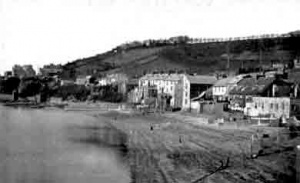 The seafront closer to Gorey Harbour before a sea wall was built and land reclaimed to take the extension of the track