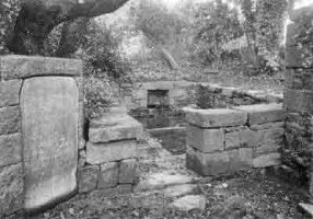 The lavoir at St Cyr, St John, with the engraved stone showing which families were entitled to use it
