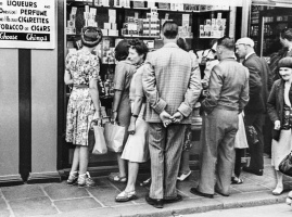 Visitors checking tobacco prices in a Wine Lodge window