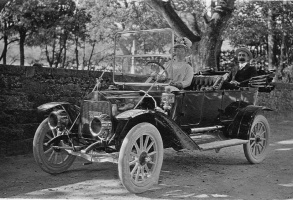Husband and wife swap places for a photograph of their new car in 1910
