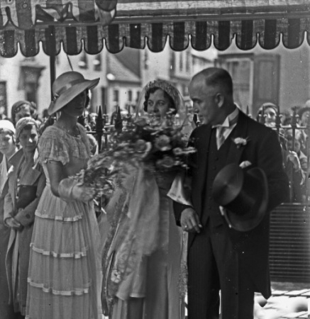 Violet Nicolle with her father and one of her bridesmaids before entering the church