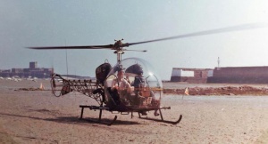 A helicopter lands close to the harbour entrance