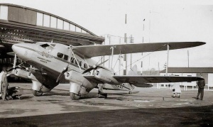 A Guernsey and Jersey Airways aircraft in front of an airport hangar