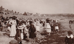 A crowded beach in the early 1900s