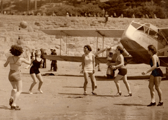 Beach games were scarcely interrupted by the arrival of an aircraft