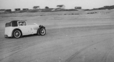 Racing past beach chalets in St Ouen's Bay