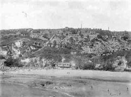 Portelet when the holiday camp first opened - wooden chalets scattered over the slopes above the beach