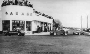 Cars race past the garage at Bel Royal
