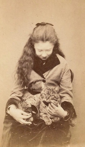 Pictures of animals as part of a formal portrait in the 19th century are very rare. This young lady with a cat was photographed by E Ogier ...