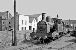 A train leaves the St Helier terminal and passes along the Esplanade