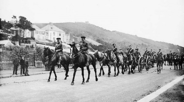 Militia artillery units parade along the road ...