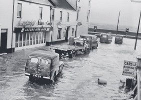 Flooding at the bottom of the street on a high tide in stormy weather on 11 January 1962