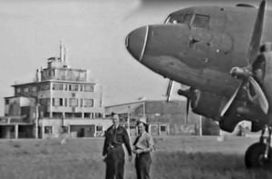 RAF personnel in front of a Dakota after the Liberation