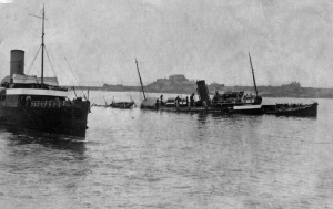 A rare amateur photograph showing the stricken vessel being passed by another steamship