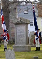 An anniversary celebration at Grouville Church. A guard of honour flanks the memorial in the churchyard to the seven grenadiers of the 83rd regiment who lost their lives fighting the French at La Rocque