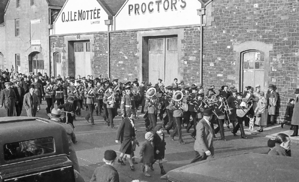 A band marches along the road in 1935