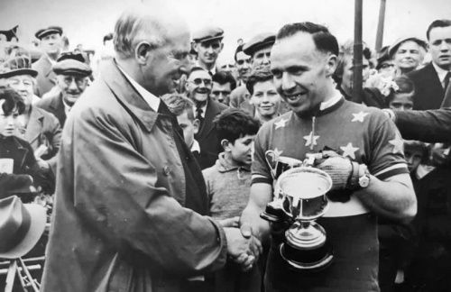 ... and receiving the winner's trophy