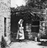 A milkmaid at an unidentified farm well