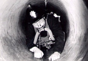 Training with breathing apparatus in a sewer pipe in 1970